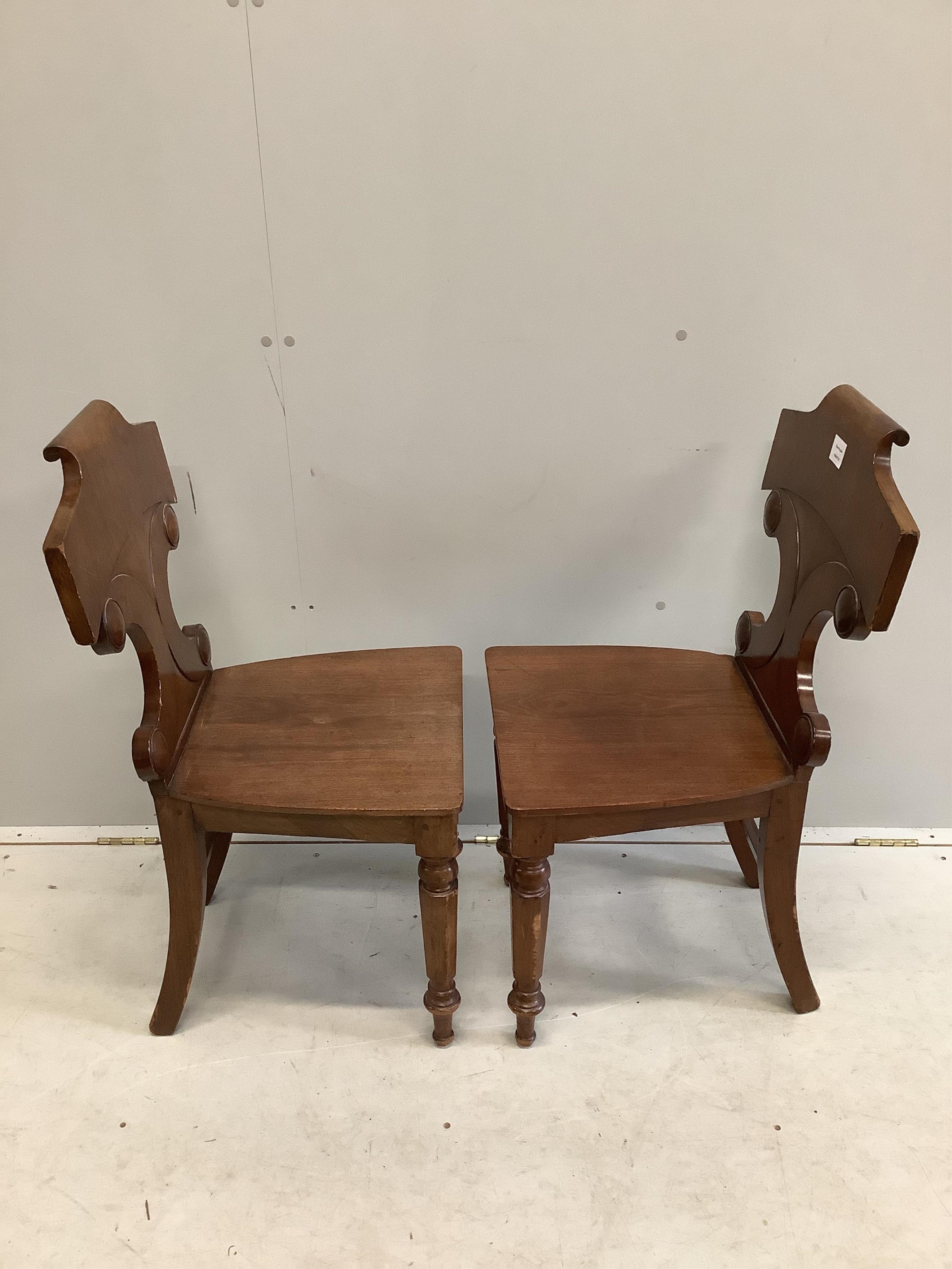 A pair of Victorian mahogany hall chairs, width 44cm, depth 40cm, height 88cm. Condition - fair